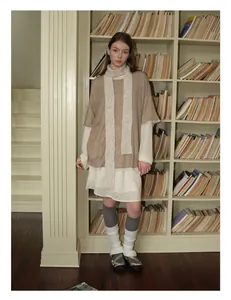Detail showing the layered wool blend scarf with a knit cardigan and lace hem dress