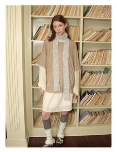 Detail showing the layered texture of a grey wool blend skinny scarf with a vintage outfit