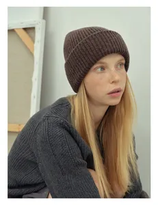 Detailed close-up of thick rib-knit dark brown 100% wool beanie with cozy texture