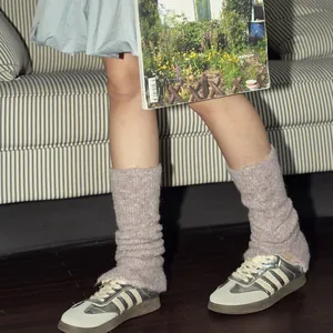 Balletcore wool blend knit leg warmers in dusty pink paired with silver striped sneakers