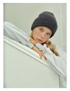 Close-up of deep grey wool ribbed knit beanie showing soft texture and folded brim
