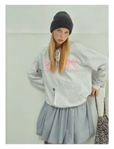 Detail showing high-quality wool knit hat texture and soft fabric on a female model