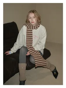 Detail of soft 100% Australian wool striped scarf paired with a casual winter outfit