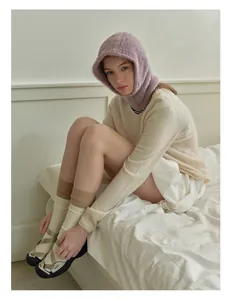 Detail of lavender faux mink balaclava hat paired with cozy winter knitted outfit