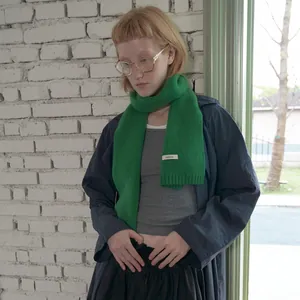 Vibrant green 100% Australian wool scarf featuring ribbed edges and minimalist woven texture