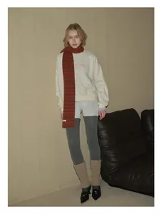 Winter outfit featuring a 100% pure wool striped scarf and beige sweatshirt for women