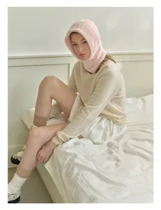 Detail of pink plush balaclava hat showing soft faux mink texture and warm hood design