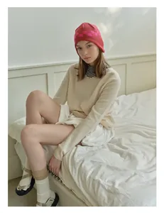 Close-up of stylish checkerboard pattern knit ear-flap hat with warm textures