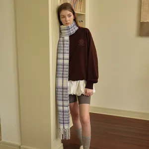 Brown sweatshirt and blue plaid wool blend scarf set for women in a cozy interior