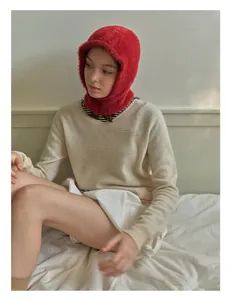 Detail shot of bright red faux mink fur balaclava showing soft knitted plush texture