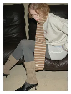 Detailed texture of a premium striped wool scarf with a soft and warm knitted finish