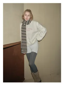 Detail of soft 100% Australian wool scarf with black and beige horizontal stripes