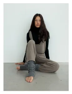 Detailed view of dark brown wool knit tank top and pants with grey leg warmers