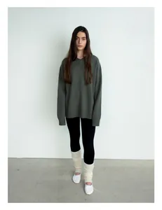 Detail of ribbed cuffs on dark grey-green knit wool blend sweater with drop shoulders