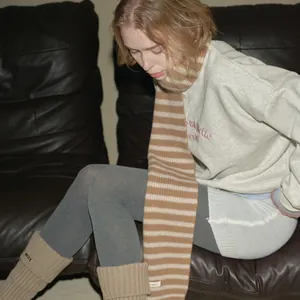 Cozy 100% Australian wool striped scarf paired with grey sweatshirt and knit leg warmers