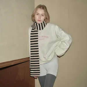 Soft 100% Australian wool scarf with black and cream stripes paired with grey sweatshirt