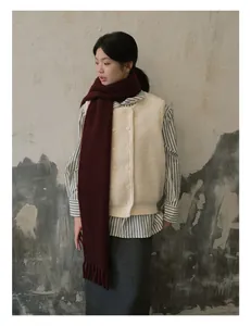 Deep burgundy wool scarf with tassels paired with minimalist knit vest and striped shirt