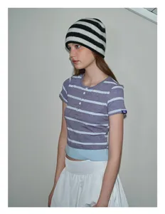 Close-up of black and white striped knitted beanie hat and purple striped polo shirt