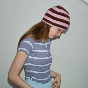 Pink and brown striped knitted wool beanie paired with a blue casual striped T-shirt