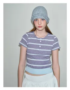 Detail shot of light grey knit beanie featuring unique ruffled edges and textured wool blend
