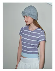 Detail shot of the grey wool blend beanie with a stylish ruffled edge and knitted texture