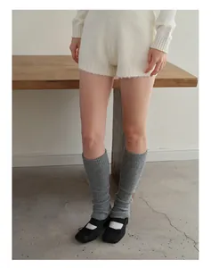 Detalle de calentadores grises de mezcla de lana con tejido de punto acanalado y zapatos Mary Jane