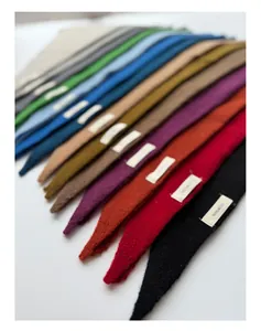 Close-up of 100% wool knitted triangular scarves showing various vibrant colors