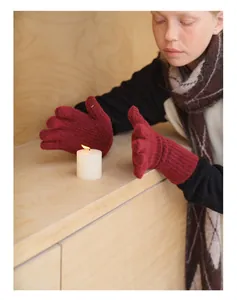 Detail of red wool blend knit gloves with ribbed cuffs and touchscreen feature