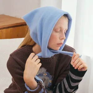 Light blue wool knit triangular shawl and headscarf for women shown in soft natural light