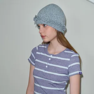 Chic grey wool blend beanie with ruffled edges paired with striped short sleeve tee