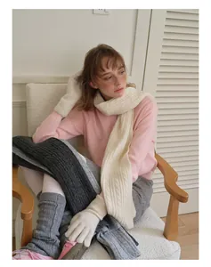 Detail of wool blend cable knit scarf set with matching mittens and leg warmers