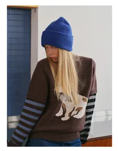 Detail of royal blue ribbed knit beanie paired with brown animal graphic sweater set