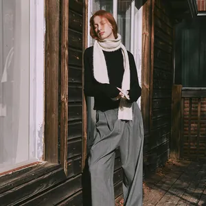 Minimalist wool blend cable knit scarf with black turtleneck and grey trousers for winter