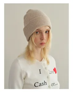 Detail of soft beige ribbed knit beanie made of yak wool blend on a model