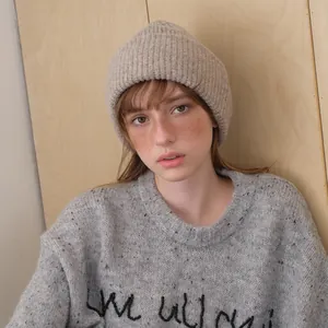 Classic chic alpaca wool blend beanie hat in soft beige worn with a casual sweater