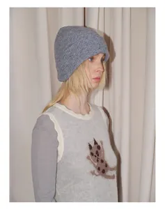 Detail of soft ribbed knit texture on a grey wool blend beanie with cartoon cat vest