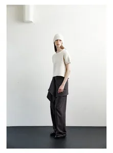 Detailed view of women's wool knit beanie paired with wide-leg trousers for a stylish look