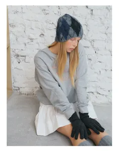 Winter outfit detail featuring argyle knit beanie, matching gloves and wool sweater