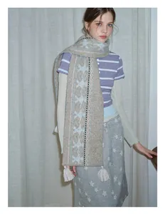 Detail of wool blend Fair Isle scarf with vintage patterns and off-white fringe tassels