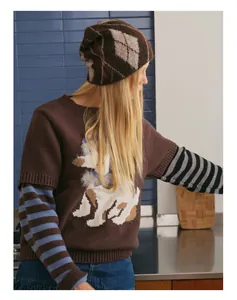 Close-up of diamond pattern knit beanie styled with a brown cartoon dog sweater