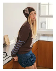 Detail of wool blend argyle beanie paired with a textured jacquard knit top and bubble skirt