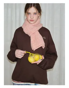 Detail of pink wool-blend chunky knit scarf paired with a casual winter outfit