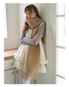 Detailed view of the soft camel alpaca wool blend scarf with classic fringe tassels