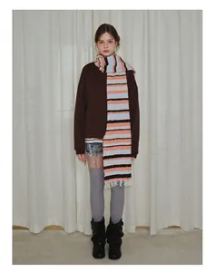 Cozy multi-color striped wool blend scarf with fringe worn with autumn sweater style