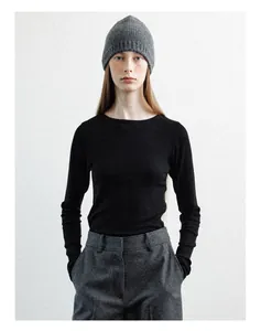 Model wearing a grey wool beanie and black ribbed long sleeve top for a minimalist style
