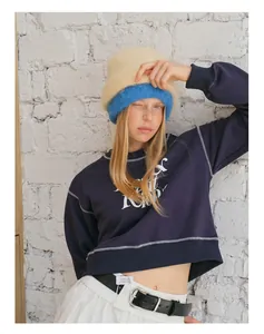 Detail view of double-layered fuzzy alpaca knit beanie with contrast stitch sweatshirt