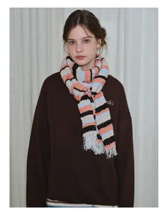 Detail of colorful striped wool blend scarf featuring soft white fringe and knit texture