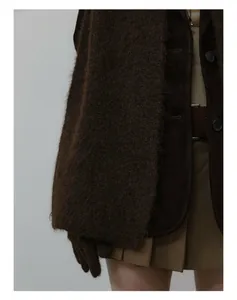 Close-up of wool blend long-hair scarf with brown suede jacket and plaid pleated skirt