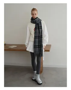 Full view of classic grey plaid wool blend scarf with fringes and minimalist winter outfit