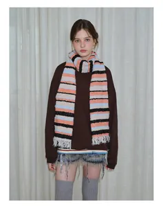 Detail of soft wool blend knit scarf with colorful horizontal stripes and fringe